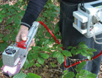 scientist using the LCpro-T plant and soil testing meter to collect data in the field